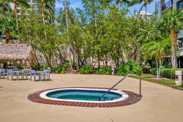 view of swimming pool with a patio area and a hot tub