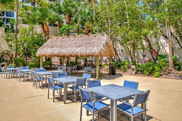 view of patio with outdoor dining space and fence