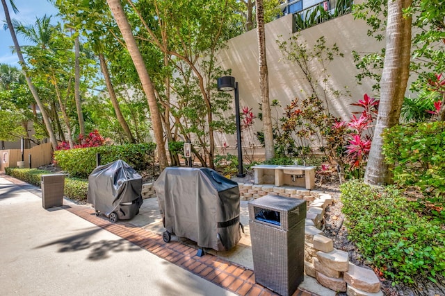 view of patio featuring area for grilling and fence