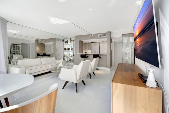 living room with visible vents and rail lighting