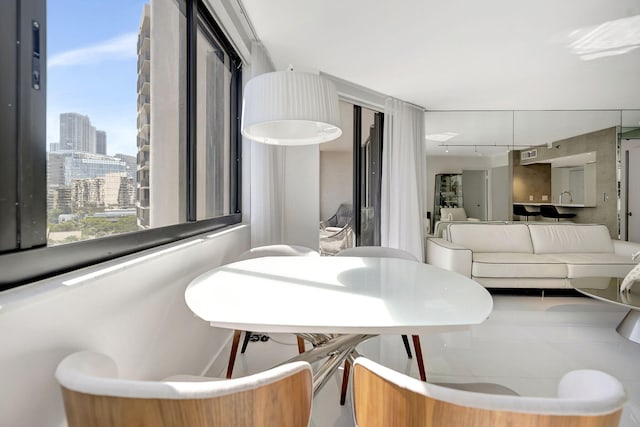 dining room with visible vents and a city view