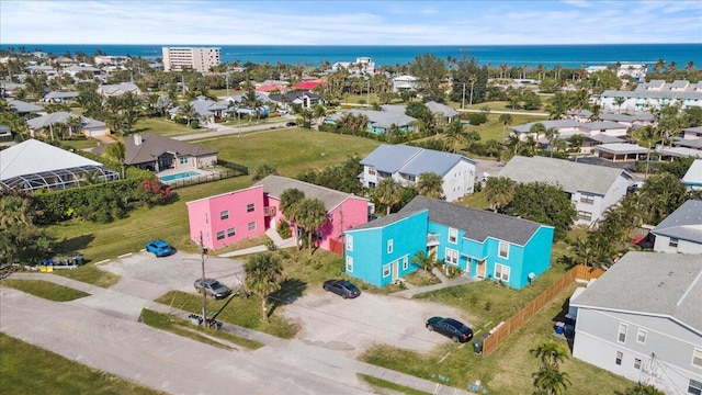 drone / aerial view featuring a water view and a residential view