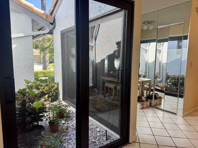 doorway with tile patterned flooring