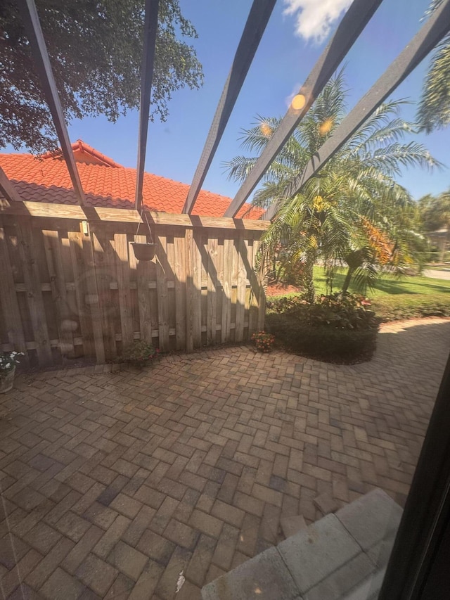 view of patio / terrace featuring a lanai