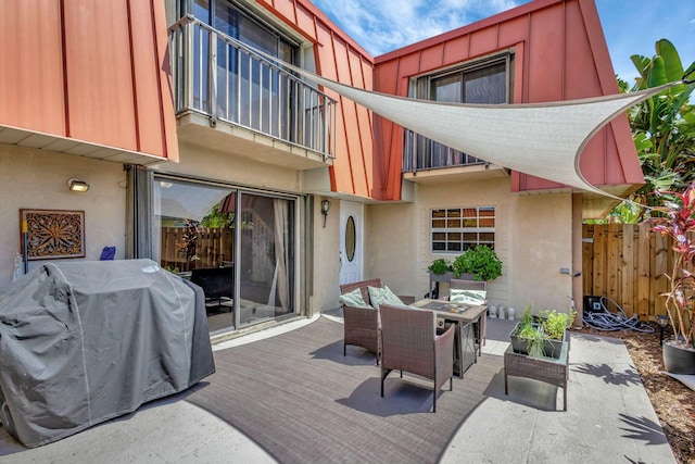 exterior space featuring an outdoor hangout area, a balcony, fence, and grilling area