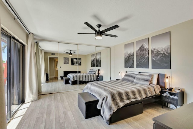 bedroom featuring a closet, visible vents, a ceiling fan, and wood finished floors