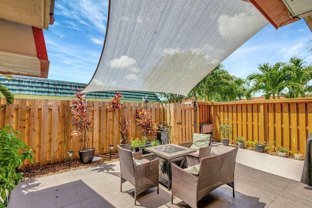 view of patio with outdoor dining space and a fenced backyard