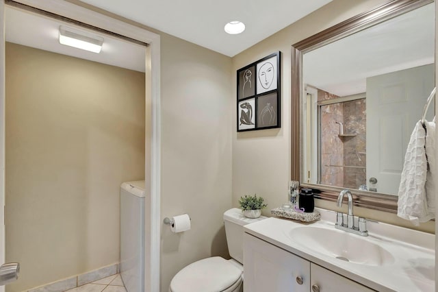 bathroom with toilet, a shower with door, tile patterned flooring, baseboards, and vanity