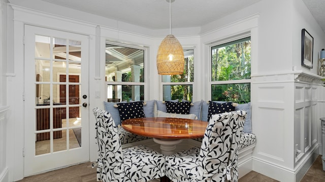 dining space featuring wood finished floors and a decorative wall