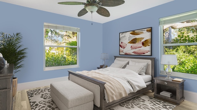 bedroom featuring multiple windows, wood finished floors, and baseboards