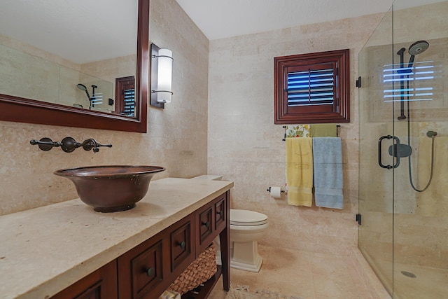 bathroom featuring vanity, tile walls, a shower stall, and toilet