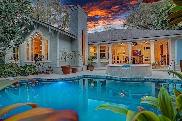 pool featuring a patio area, a ceiling fan, and an outdoor hot tub