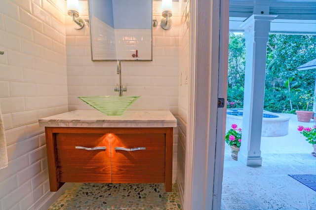 bathroom featuring tile walls and vanity