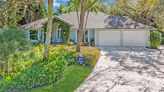 single story home with a garage and driveway