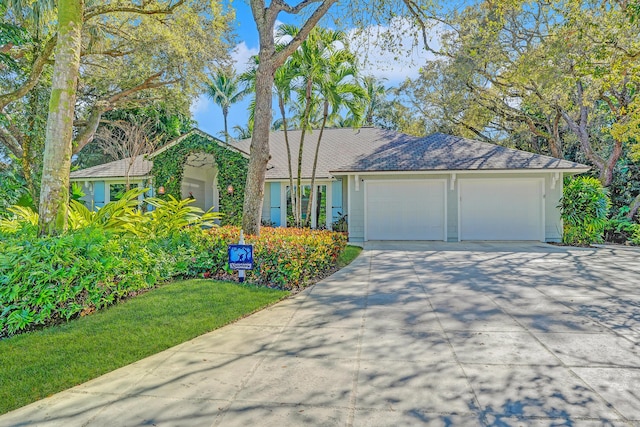 view of front of home with concrete driveway and a garage