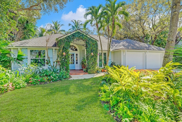 single story home with a front yard and an attached garage