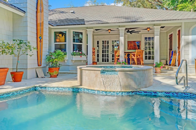 pool with an in ground hot tub, a patio area, french doors, and ceiling fan