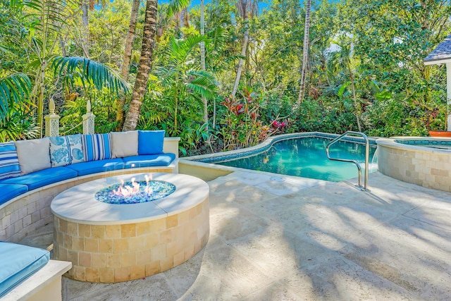 pool with an outdoor fire pit, an in ground hot tub, and a patio area