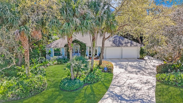 view of front of house with driveway, a front yard, and an attached garage