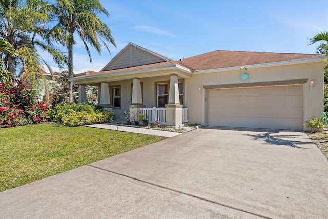 view of front facade featuring a front lawn, concrete driveway, covered porch, stucco siding, and a garage