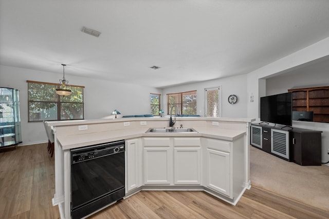 kitchen with a sink, visible vents, dishwasher, and light countertops