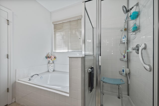 bathroom featuring a garden tub and a stall shower