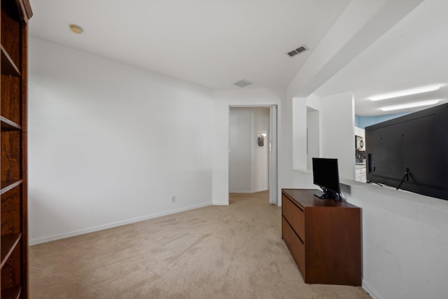 living area featuring light colored carpet, visible vents, and baseboards