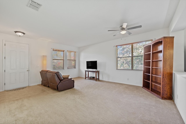 living area featuring light carpet, visible vents, and a wealth of natural light