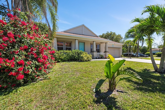 view of front of property with a front yard, covered porch, stucco siding, driveway, and an attached garage