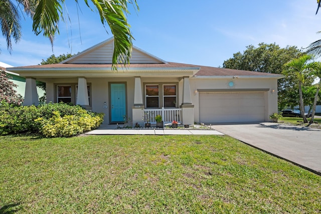 view of front facade featuring a front yard, an attached garage, concrete driveway, and stucco siding