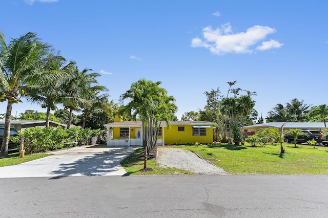 view of front of property with concrete driveway and a front lawn