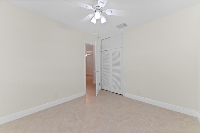 unfurnished bedroom with a closet, visible vents, baseboards, and light tile patterned flooring