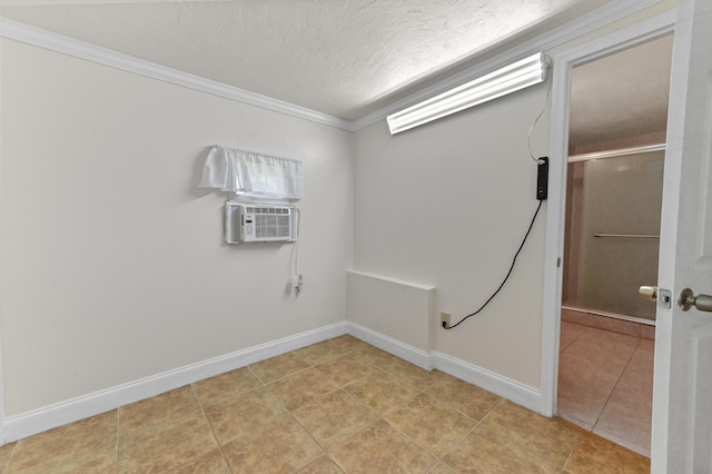 laundry room featuring crown molding, light tile patterned floors, baseboards, and a textured ceiling