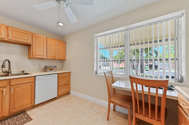 kitchen featuring light brown cabinetry, a sink, light countertops, dishwasher, and ceiling fan