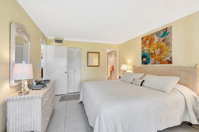 bedroom featuring light tile patterned floors, visible vents, a closet, and ornamental molding