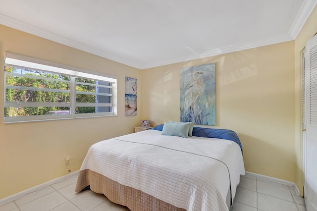 bedroom with tile patterned floors, crown molding, and baseboards