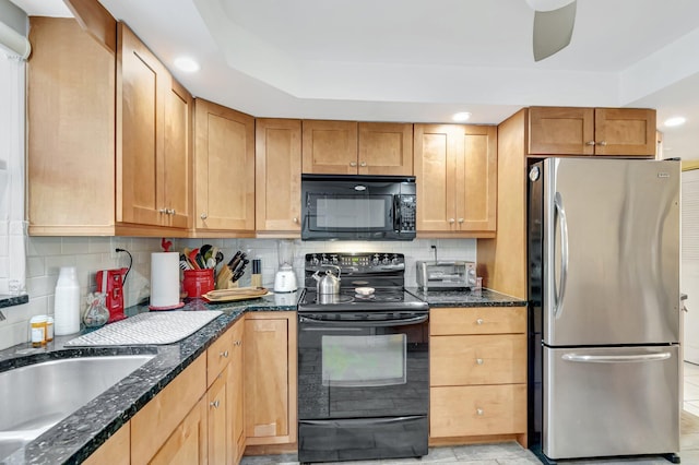 kitchen with tasteful backsplash, a toaster, dark stone counters, black appliances, and a sink