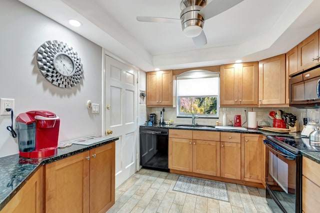 kitchen featuring dark stone countertops, a sink, black appliances, tasteful backsplash, and light wood-type flooring