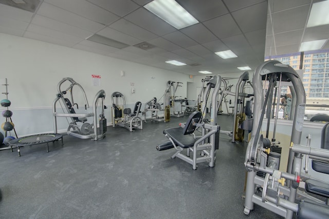 gym with a paneled ceiling