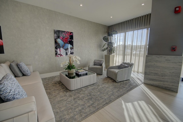 living area with recessed lighting and wood finished floors