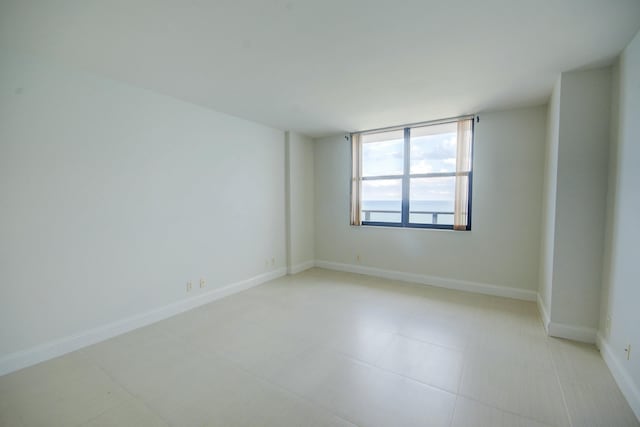 spare room featuring baseboards