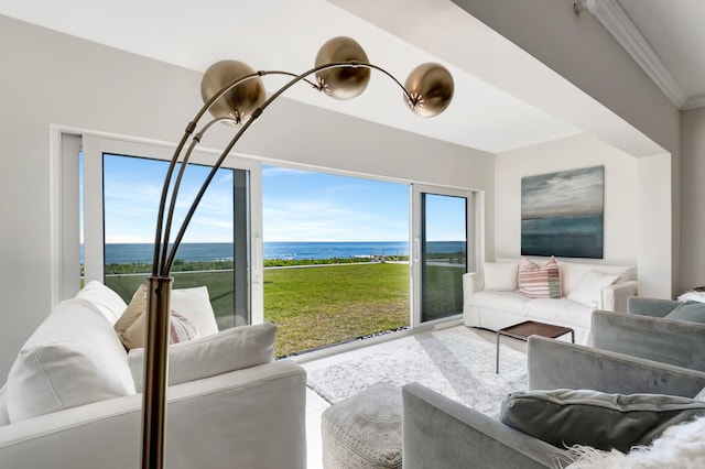 living area featuring an inviting chandelier, crown molding, and a water view