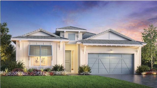 view of front facade featuring stucco siding, driveway, a front yard, and an attached garage