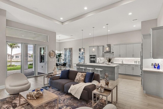 10097 Driftwood Way, Palm Beach Gardens, FL 33412 - living room with light wood-style floors, recessed lighting, and visible vents