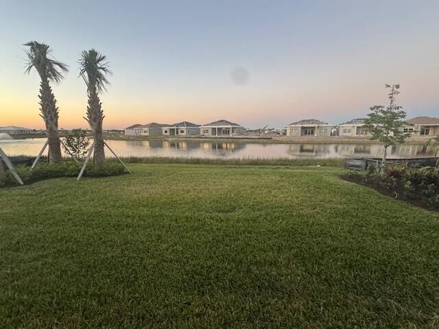 yard at dusk with a water view