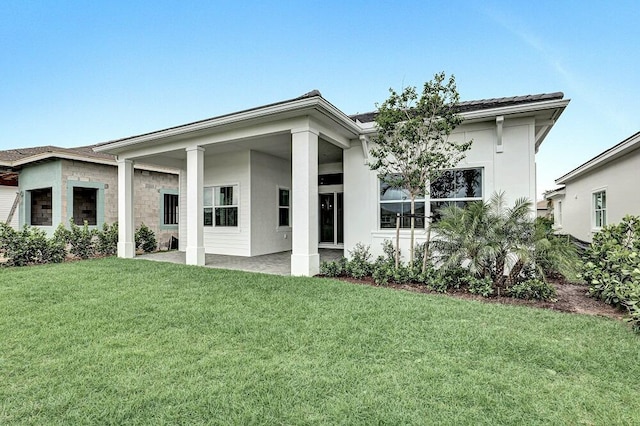 10097 Driftwood Way, Palm Beach Gardens, FL 33412 - back of house with a lawn, a patio area, and stucco siding