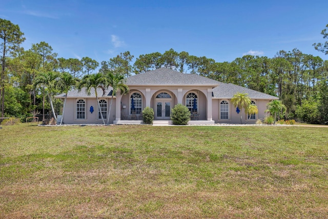 view of front of property featuring french doors, a front lawn, and stucco siding