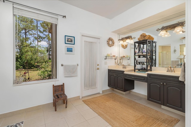 full bathroom with tile patterned floors, double vanity, and a shower