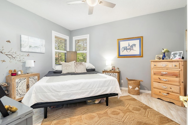 bedroom with light wood-style floors and a ceiling fan