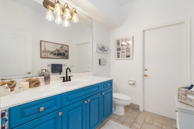 bathroom with vanity, a chandelier, and toilet